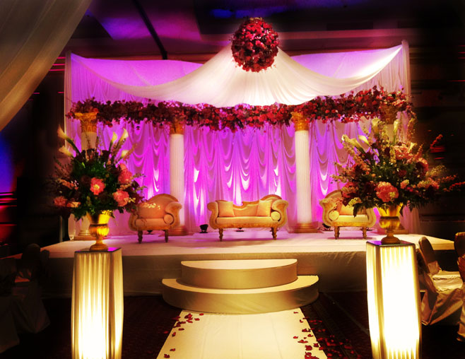The giant candle wall backdrop and neutral color tones of gold 