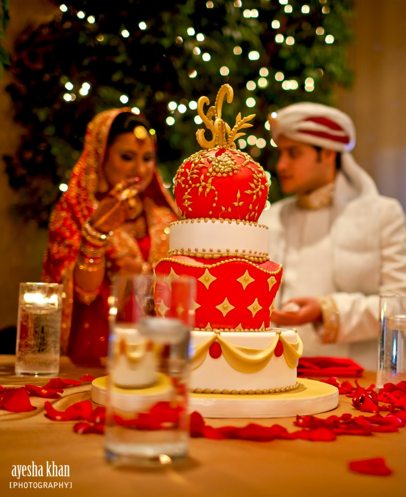 The bride and groom, Sana and Shahzeb with their beautiful red, white and gold wedding cake. Made by Sweet Heather Anne. Photography by Ayesha Khan - The Muslim Bride The bride and groom Sana and Shahzeb with their wedding cake The Muslim Bride 837x1024 The Muslim Bride Special Wedding Feature: Sana and Shahzebs Wedding Reception